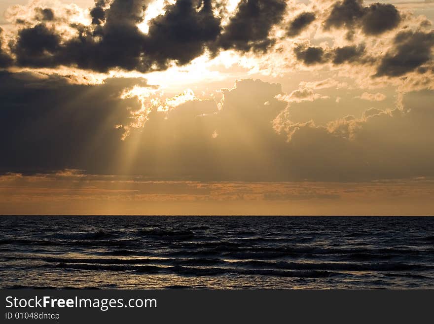 The sea, clouds and solar beams