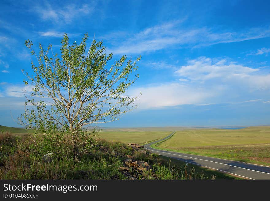 Road, clouds and the blue sky