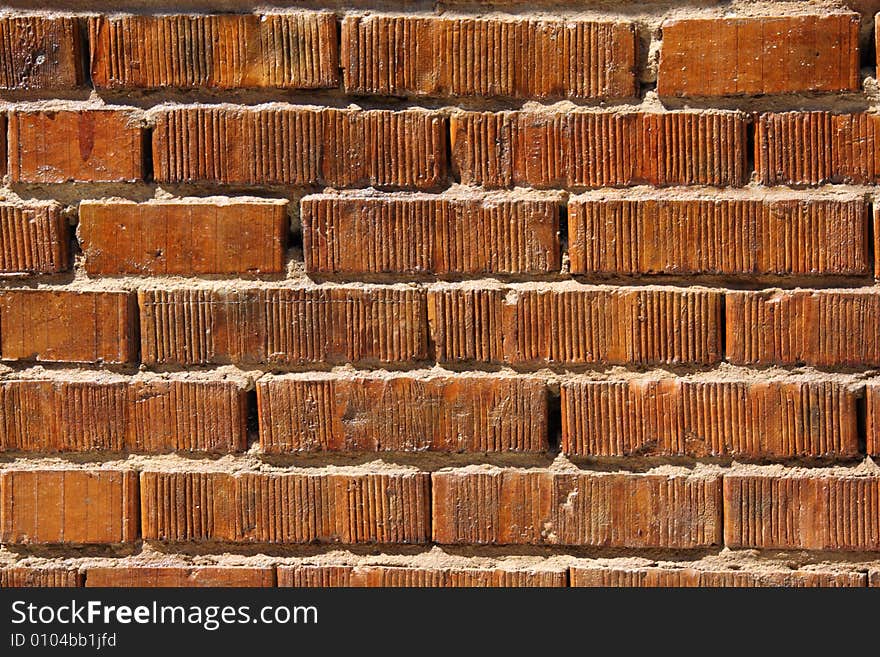 Wall with bright saturated orange bricks. Wall with bright saturated orange bricks