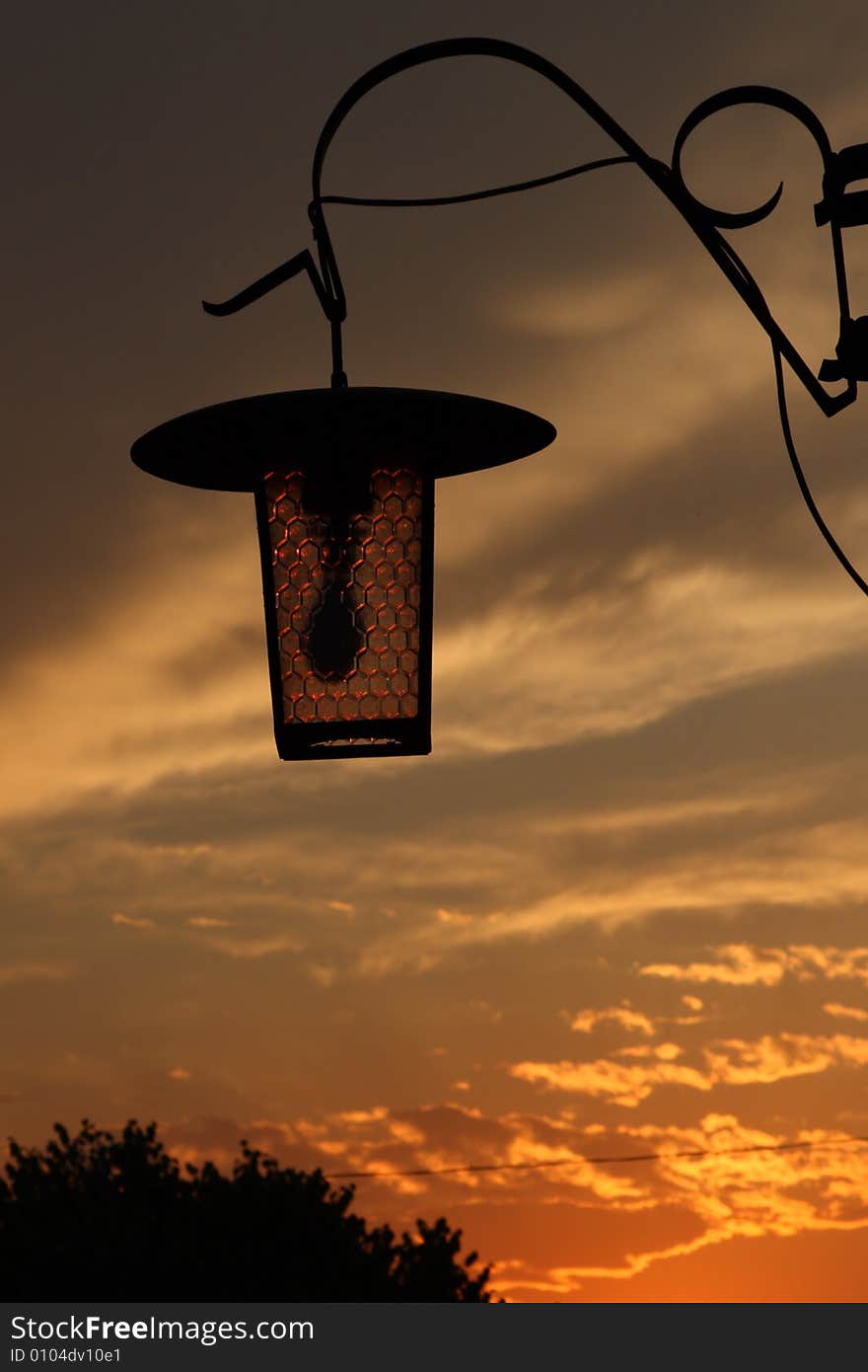 Bright dramatic sunset with lamp silhouette