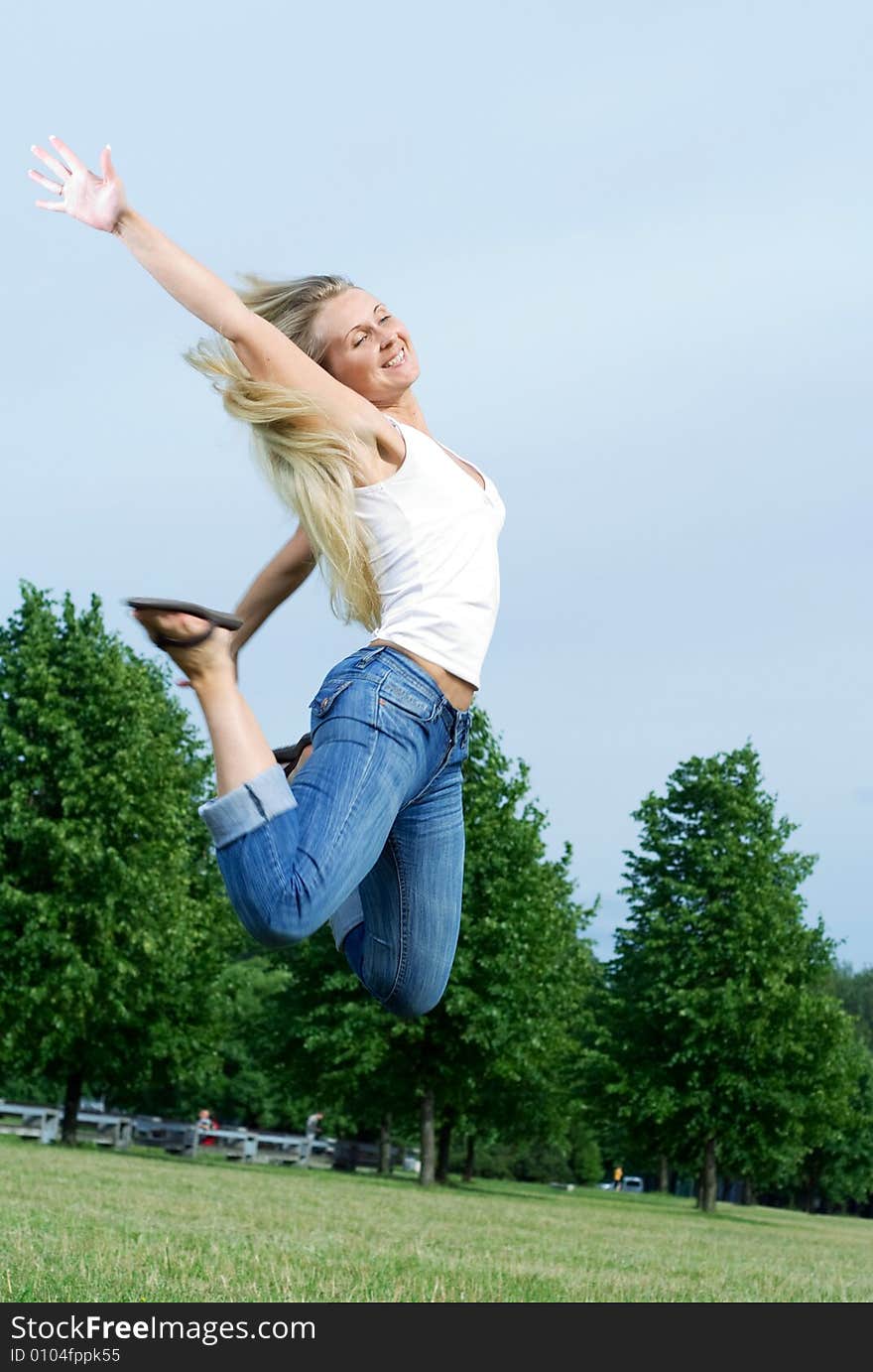 Happy jumping woman in the park. Happy jumping woman in the park.