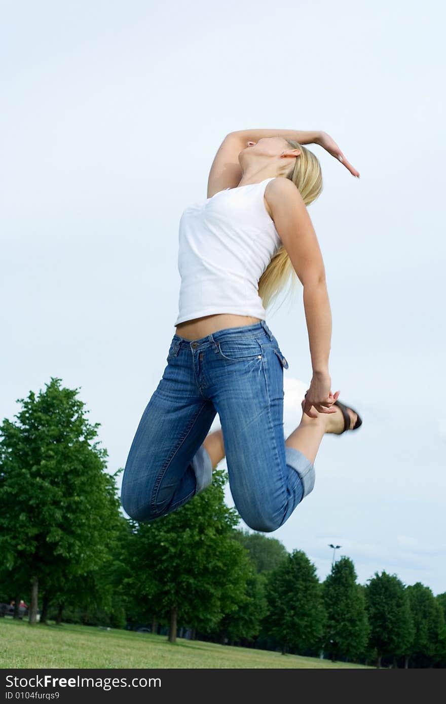 Happy jumping woman in the park. Happy jumping woman in the park.