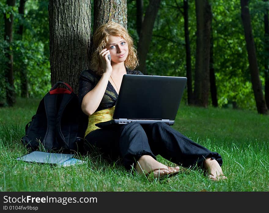 Student girl with laptop in the park. Student girl with laptop in the park.