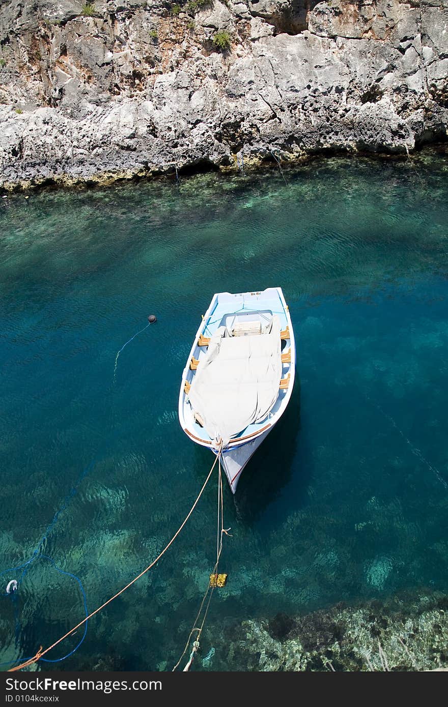 Little boat in clear water bay. Little boat in clear water bay