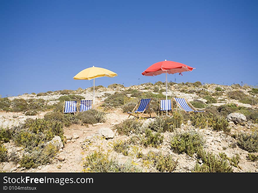 Two sun umbrella with five on a rock. Two sun umbrella with five on a rock