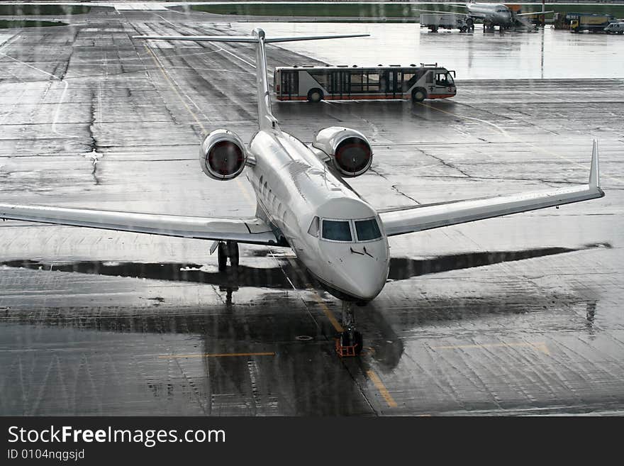 The airliner behind the window in a rainy day