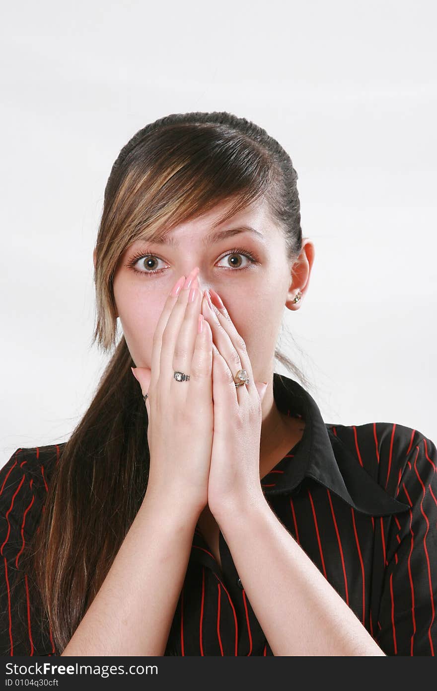 The surprised girl shouts having closed a mouth hands