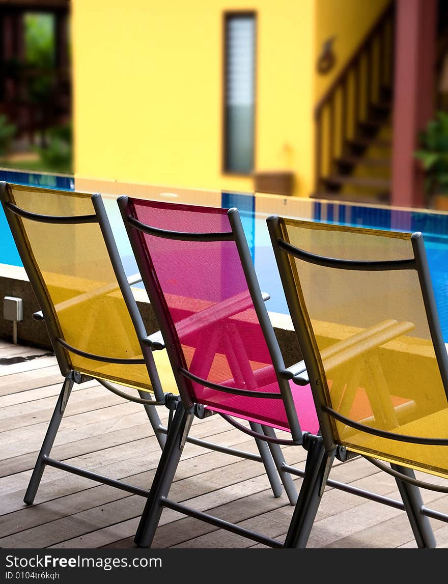 Color   deckchairs,  by the pool