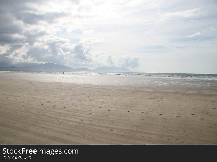 Two people walking on a beach. Two people walking on a beach