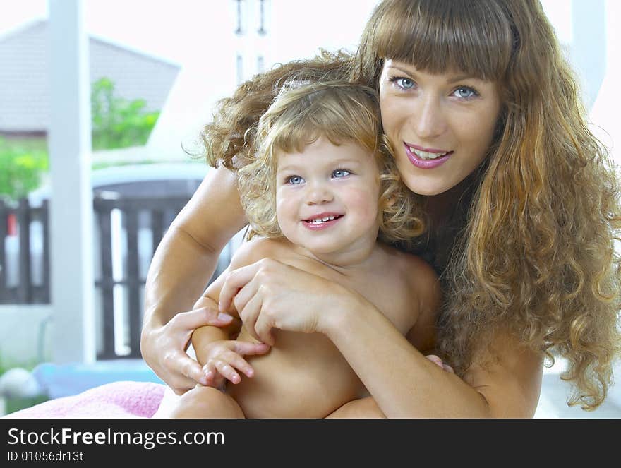 High key portrait of happy mother with baby. High key portrait of happy mother with baby