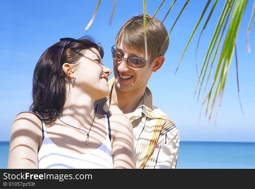 A portrait of attractive couple having date on the beach. A portrait of attractive couple having date on the beach