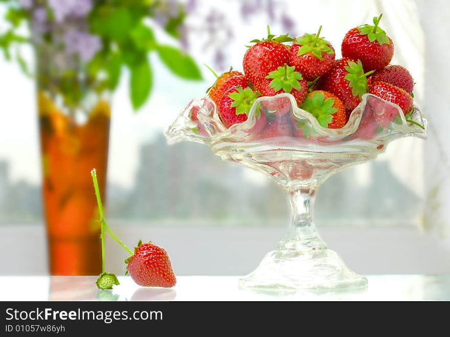 High key photo of fruit dish filled with nice red strawberries. High key photo of fruit dish filled with nice red strawberries