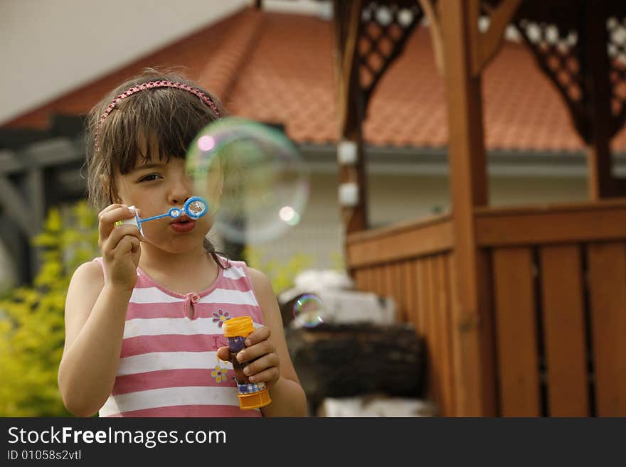 Small girl puts forth soap bubbles. Small girl puts forth soap bubbles