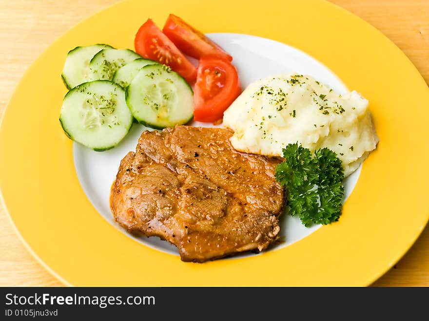 Barbecue with steaks of pork,puree potatoes,salad.