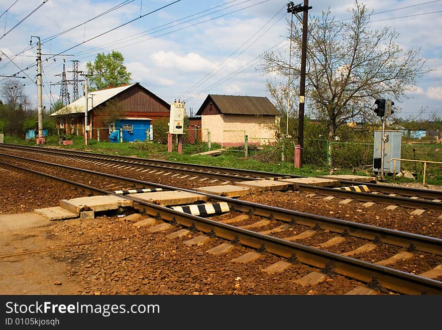 A railroad pedestrian crossing with light signals. A railroad pedestrian crossing with light signals