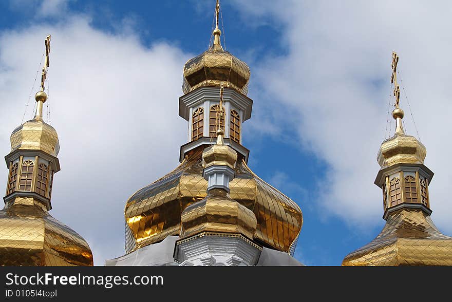 Golden cupola of church on blue sky