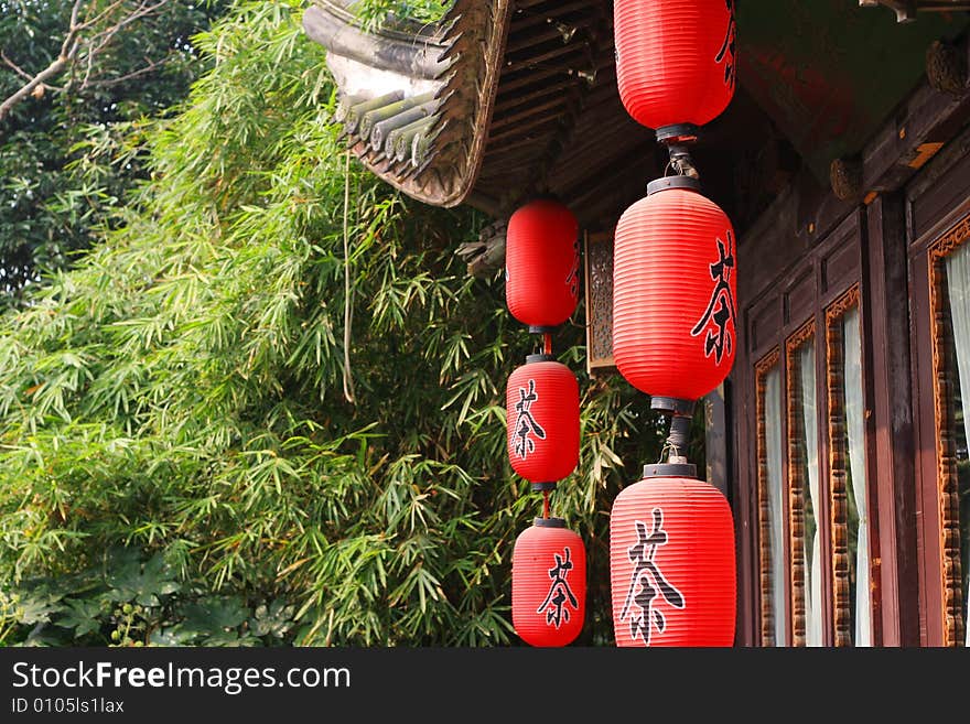 Red  chinese lantern hung before old building.chinese word 'tea' write on the lantern.