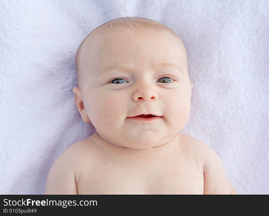 Little Baby Smiling Laying on a Blanket Naked