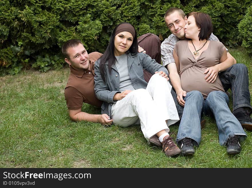 Happy friends relaxing on grass