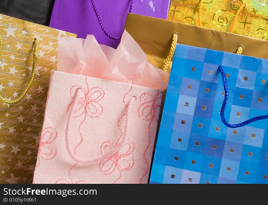 Collection of gift bags in different colors and patterns.