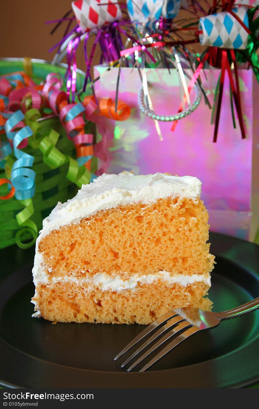 One piece of Birthday cake with white frosting. One piece of Birthday cake with white frosting.