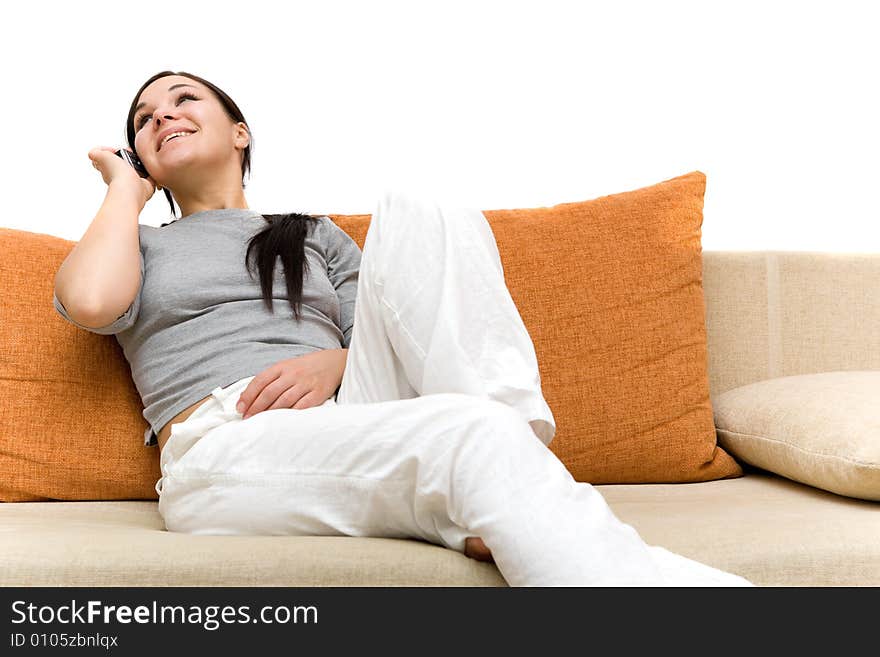 Attractive brunette woman with cell phone on sofa. Attractive brunette woman with cell phone on sofa