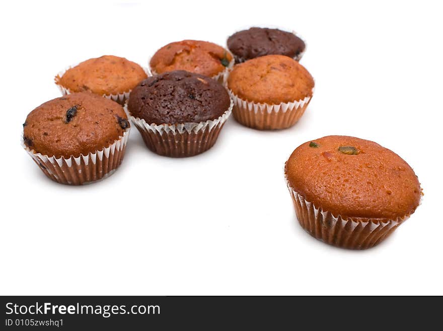 Many muffins put together on white background.