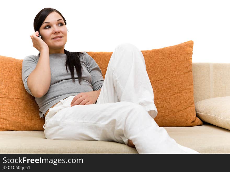 Attractive brunette woman with cell phone on sofa. Attractive brunette woman with cell phone on sofa