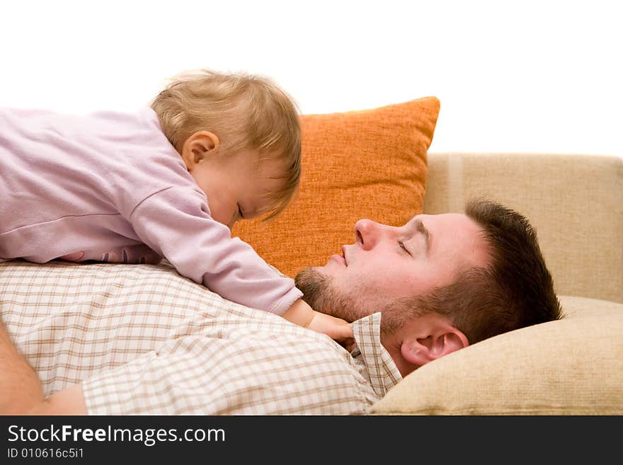 Father and baby girl playing on sofa. Father and baby girl playing on sofa