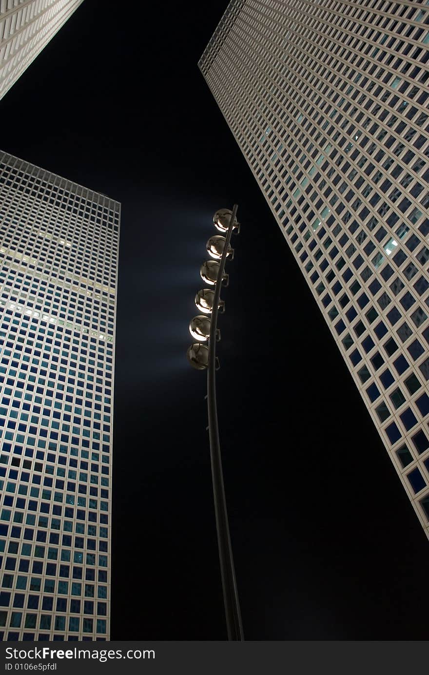 A complex of scyscrapers in Tel-Aviv Israel with a projector ligh towords the next building. A complex of scyscrapers in Tel-Aviv Israel with a projector ligh towords the next building