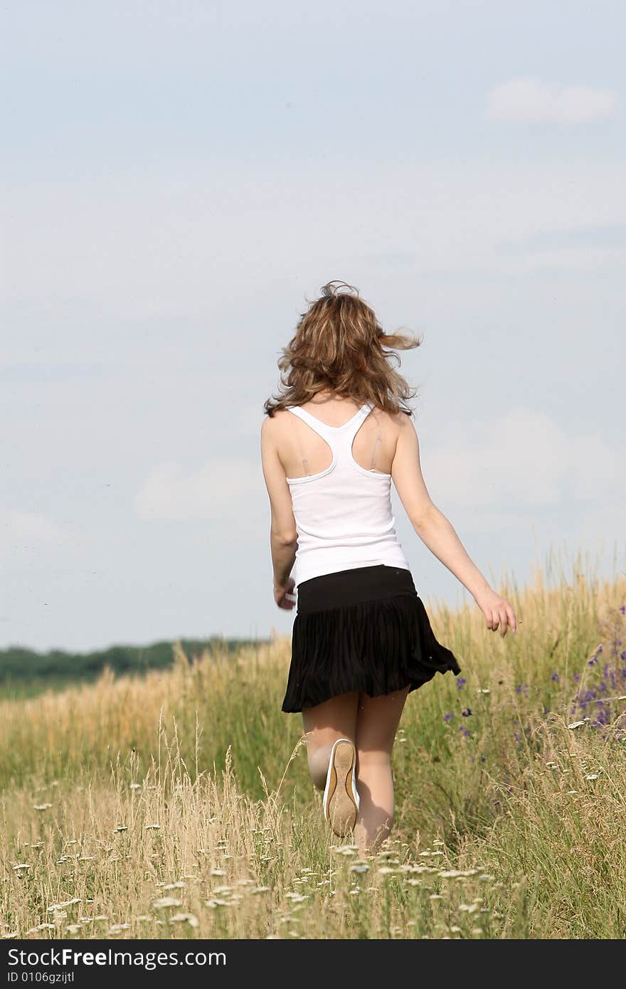 A beautiful girl running on the field