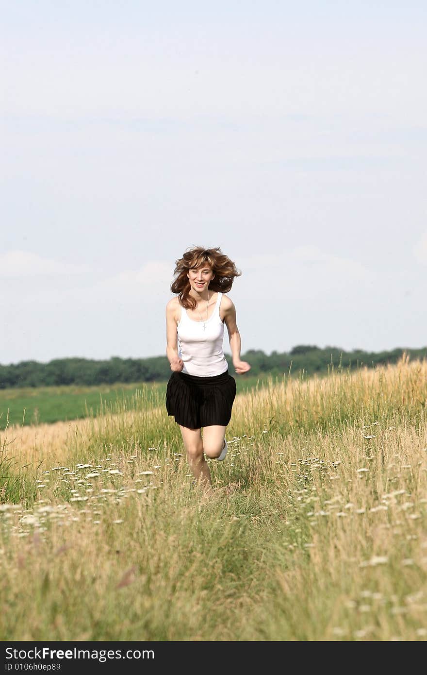 A beautiful girl running on the field