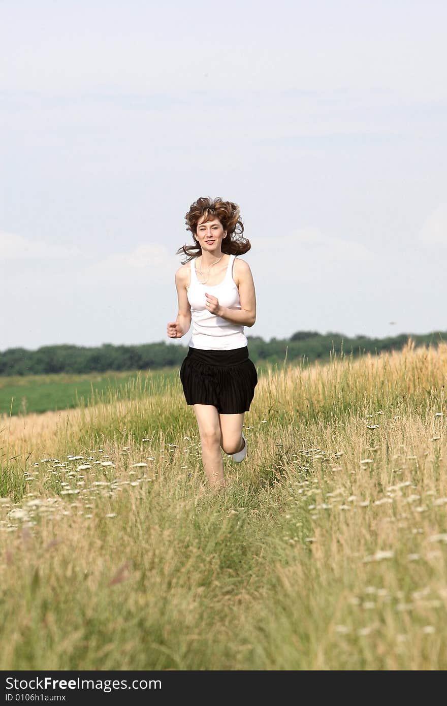 A beautiful girl running on the field