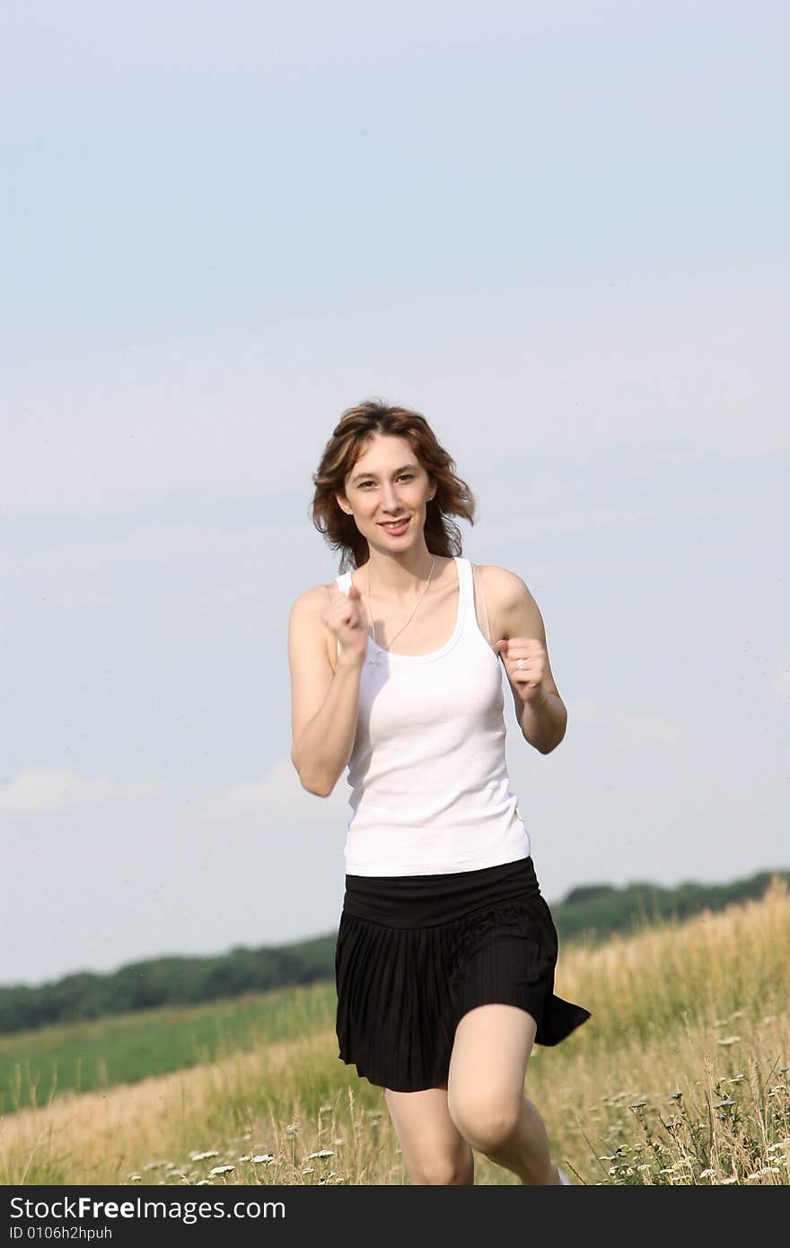 A beautiful girl running on the field