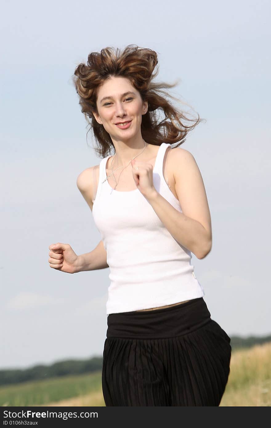 A beautiful girl running on the field