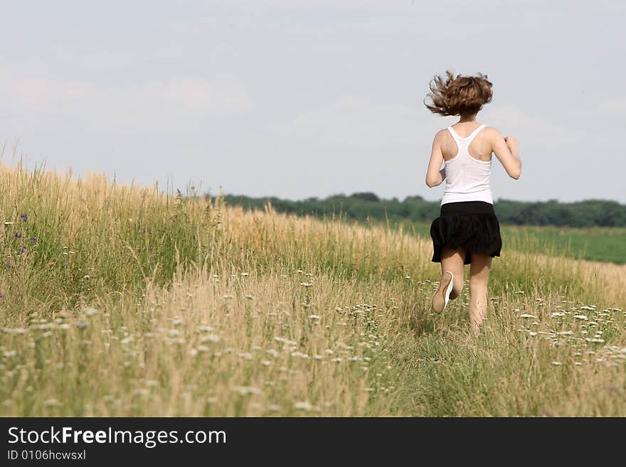 A beautiful girl running on the field