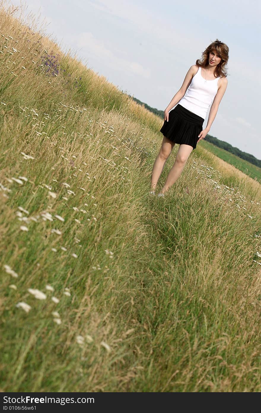 A beautiful girl running on the field. A beautiful girl running on the field