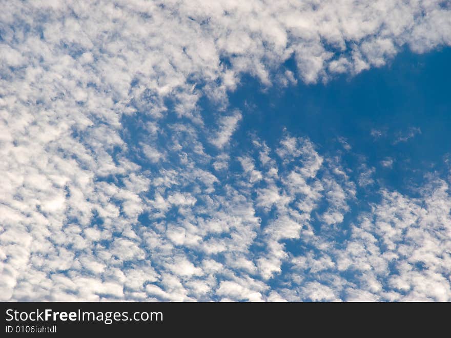 White clouds on a background of the blue sky