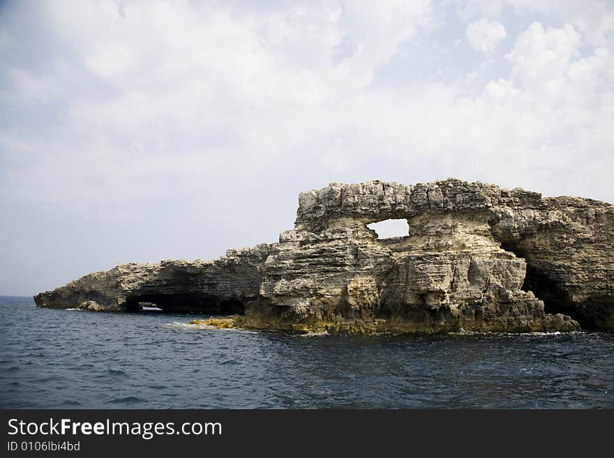 Rock, sea, clouds and blue sky