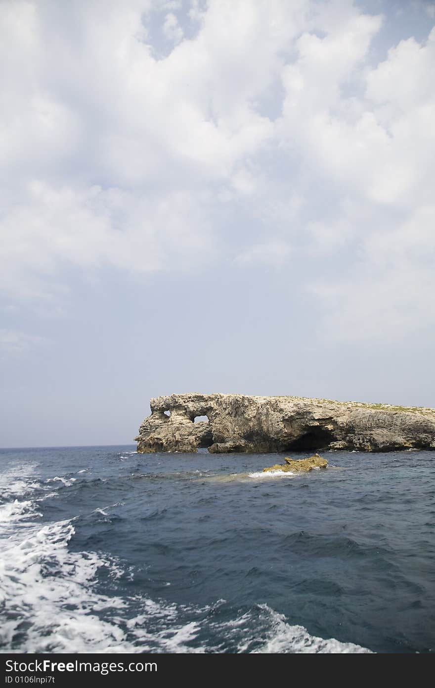 Rock, sea, clouds and blue sky