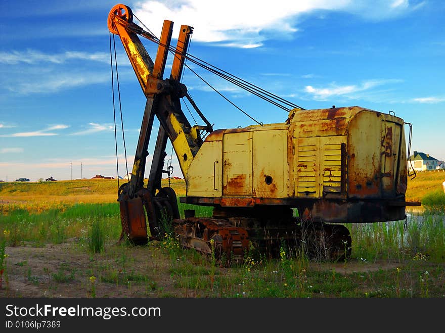 Old rusty excavator in sunset light