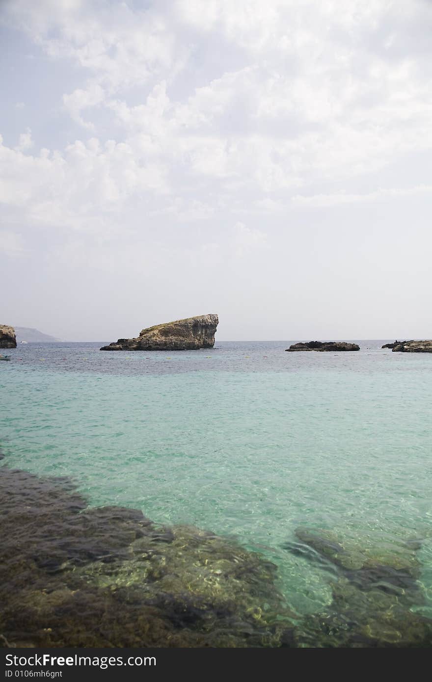 Rock, sea, clouds and blue sky