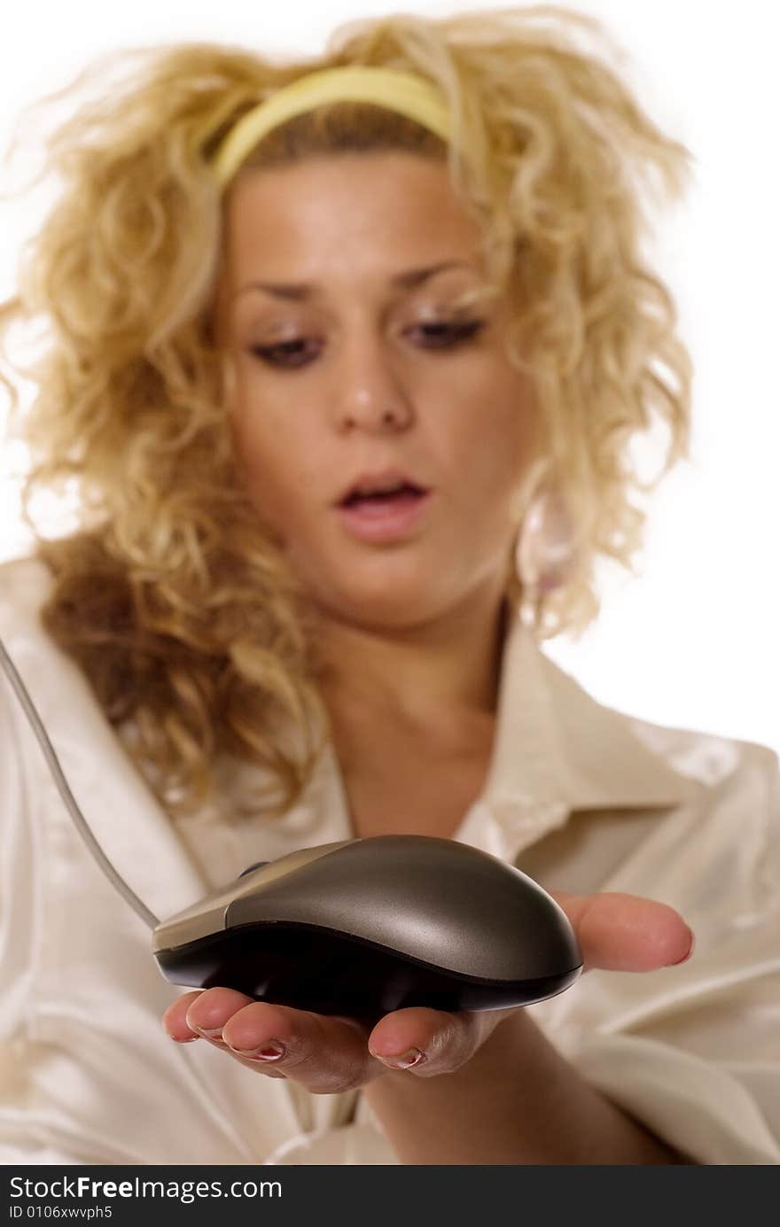 Young blonde woman holding mouse input device, focus on mouse