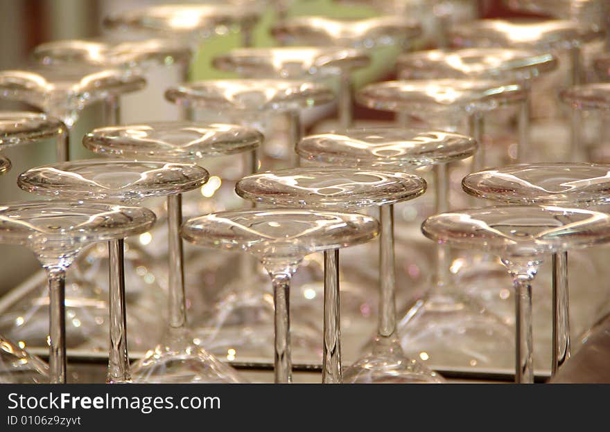 Several rows of upside down wineglasses, shimmering on a bar in a winery (vineyard). Adelaide, South Australia.