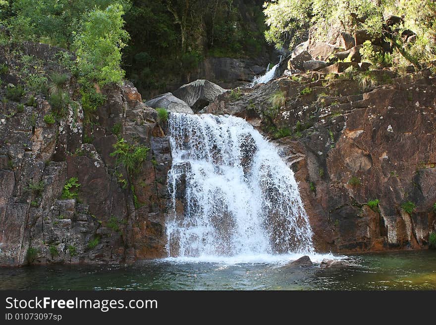 Waterfall with trees and transparent water. Waterfall with trees and transparent water