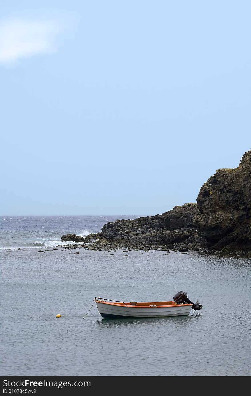 Small motor boat in rocky bay