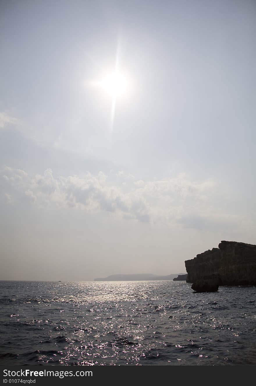 Sun, water, rock and clouds. Sun, water, rock and clouds