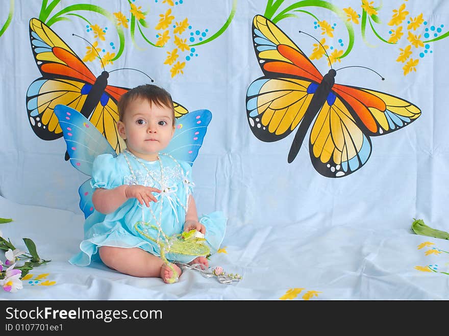 A picture of a sweet little girl in a fancy blue dress with butterfly wings. A picture of a sweet little girl in a fancy blue dress with butterfly wings