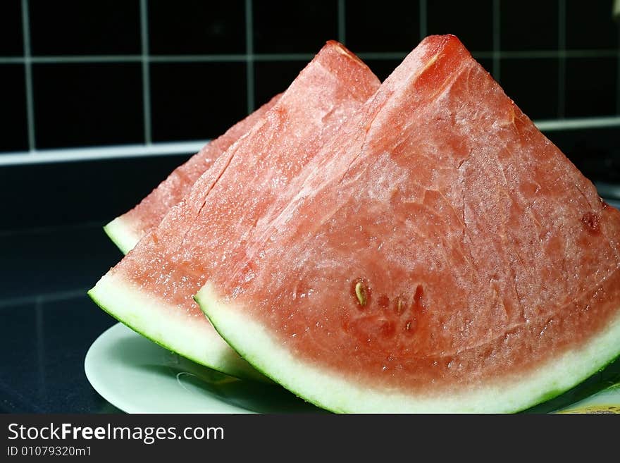 Fresh cut Watermelon in a black tile background