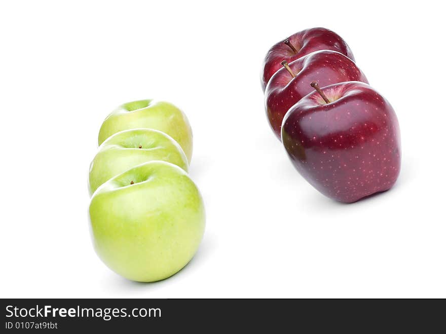 Red and green apples lined up on a white background